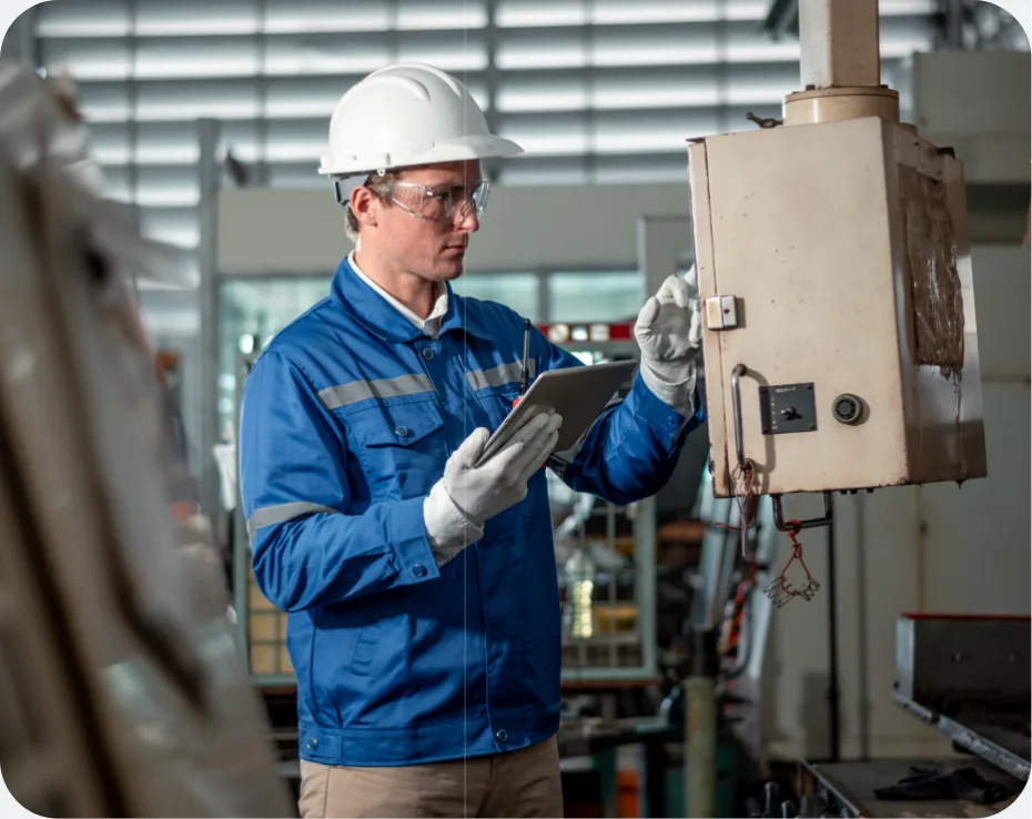 Toplink engineer checking a machine on the production floor